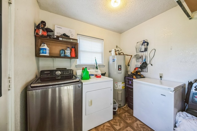 laundry area with water heater, a textured ceiling, washer and clothes dryer, and dark parquet flooring