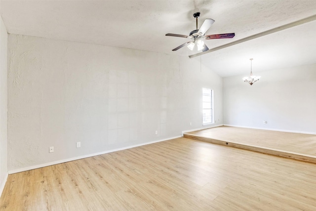 spare room with lofted ceiling with beams, ceiling fan with notable chandelier, and light hardwood / wood-style flooring