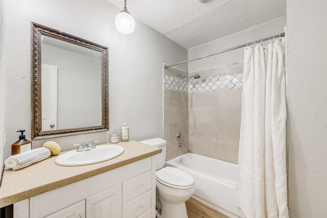 full bathroom with toilet, hardwood / wood-style floors, shower / tub combo, a textured ceiling, and vanity