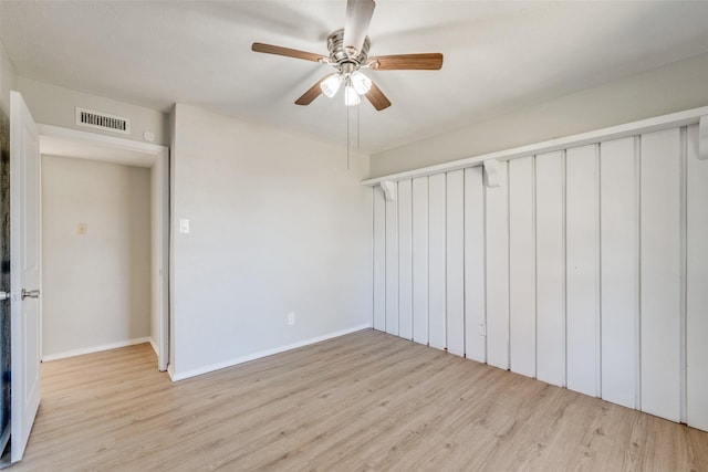 empty room with ceiling fan and light hardwood / wood-style flooring