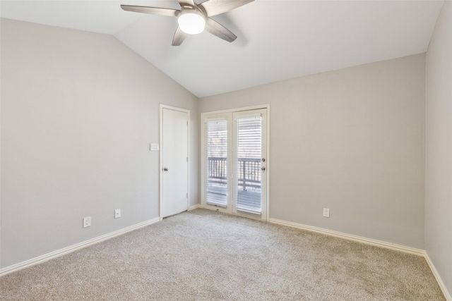 carpeted spare room featuring ceiling fan and vaulted ceiling