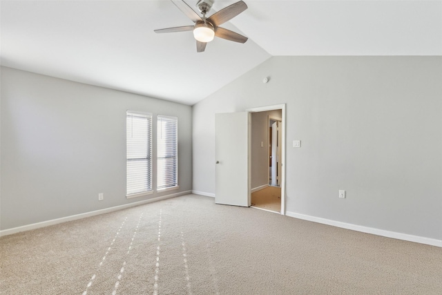 carpeted spare room with lofted ceiling and ceiling fan