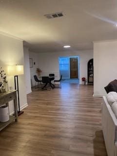 living room featuring crown molding and dark hardwood / wood-style flooring