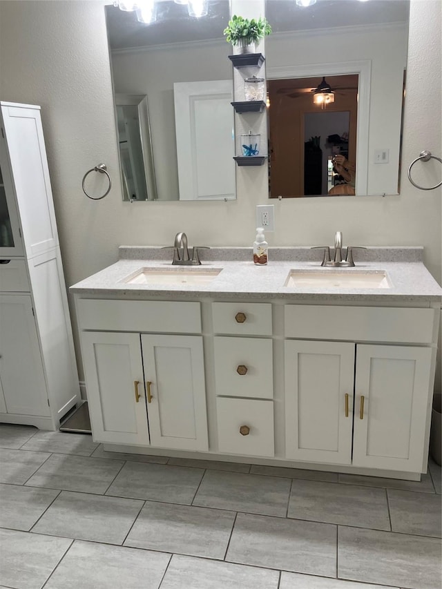 bathroom featuring crown molding, ceiling fan, and vanity