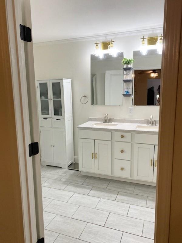 bathroom with ornamental molding and vanity