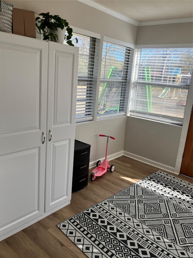 bedroom featuring crown molding and wood-type flooring