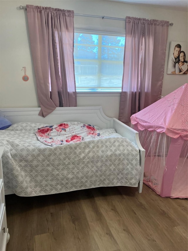 bedroom with wood-type flooring