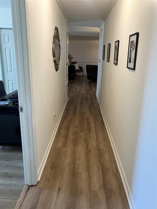 hall featuring dark hardwood / wood-style flooring and crown molding