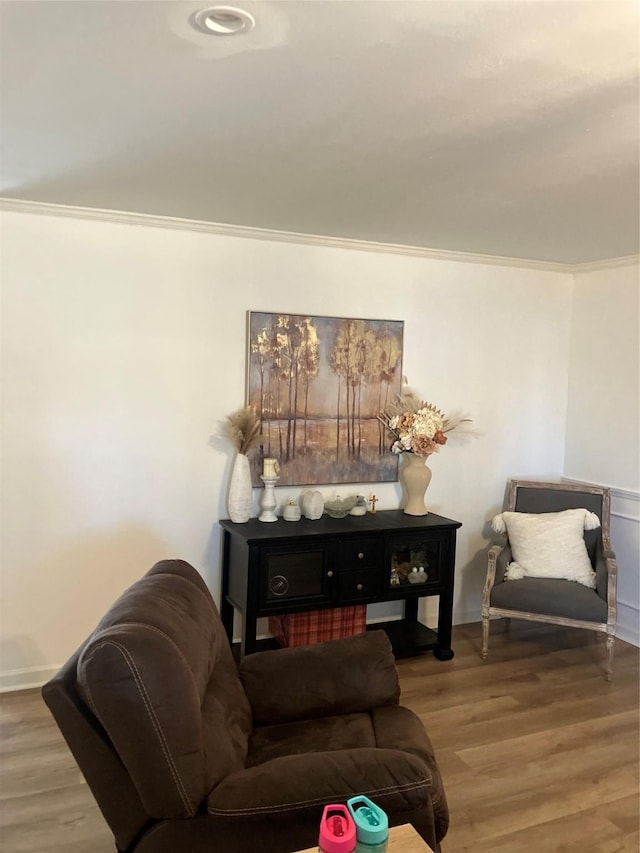 living room featuring hardwood / wood-style flooring and ornamental molding