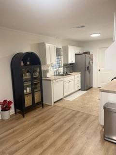 kitchen featuring stainless steel refrigerator with ice dispenser, white dishwasher, white cabinets, and light wood-type flooring