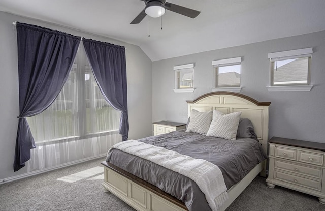 bedroom featuring ceiling fan, light colored carpet, and lofted ceiling