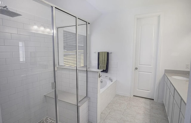 bathroom with plus walk in shower, lofted ceiling, tile patterned floors, and vanity