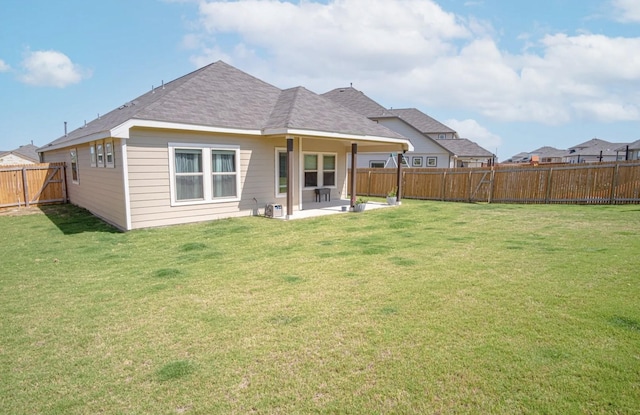 rear view of house with a patio area and a lawn