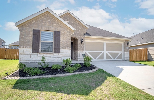 view of front of property with a front lawn and a garage