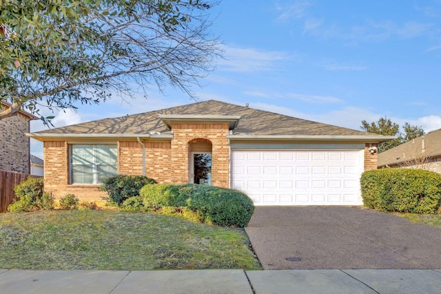 ranch-style home featuring a front lawn and a garage