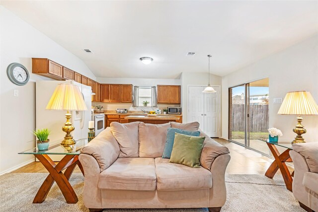 bedroom with lofted ceiling, baseboards, visible vents, and light colored carpet