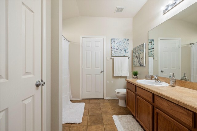 bathroom featuring vaulted ceiling, vanity, toilet, and tile patterned floors