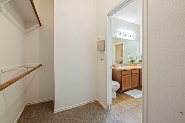 bathroom with vanity, toilet, and tile patterned floors