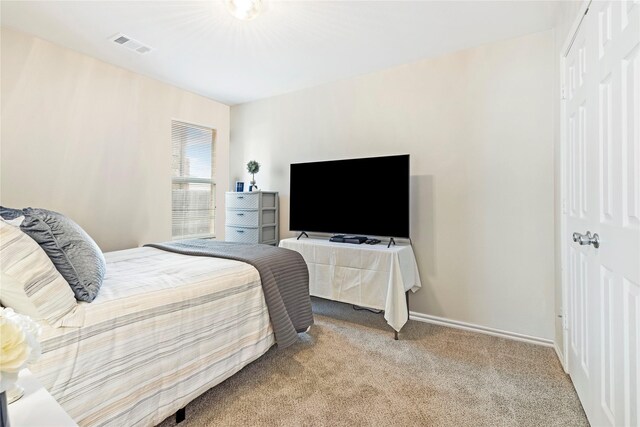 unfurnished bedroom featuring light carpet, baseboards, and a closet