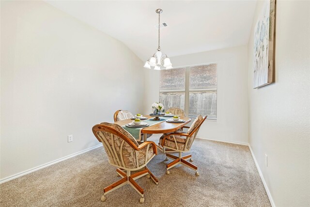 carpeted dining room with an inviting chandelier and baseboards