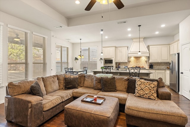 living room featuring ceiling fan and dark hardwood / wood-style floors