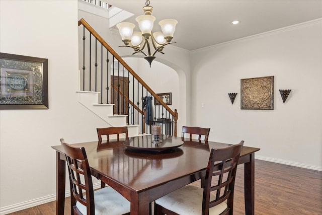 dining room featuring ornamental molding, dark hardwood / wood-style flooring, and a notable chandelier