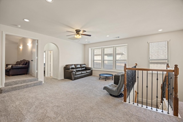 carpeted living room featuring ceiling fan