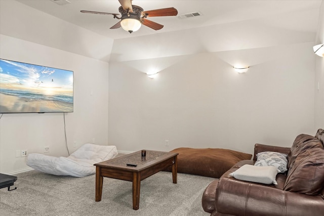 carpeted living room featuring ceiling fan and vaulted ceiling