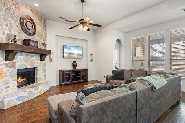 living room with ceiling fan, dark hardwood / wood-style flooring, and a fireplace