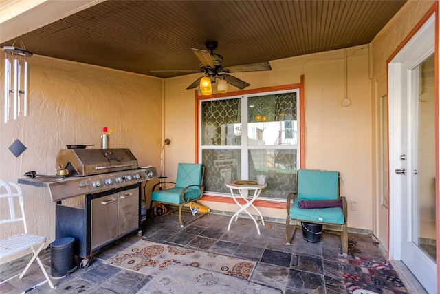 view of patio with ceiling fan and area for grilling