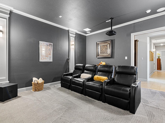 home theater room featuring light carpet, a textured ceiling, crown molding, and ornate columns