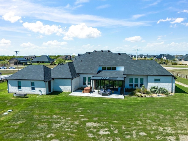 back of house featuring a patio area and a lawn