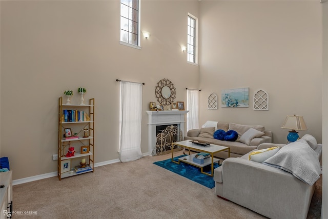 living room with carpet floors and a high ceiling