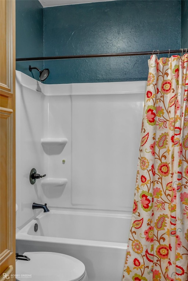 bathroom with toilet and shower / bathtub combination with curtain