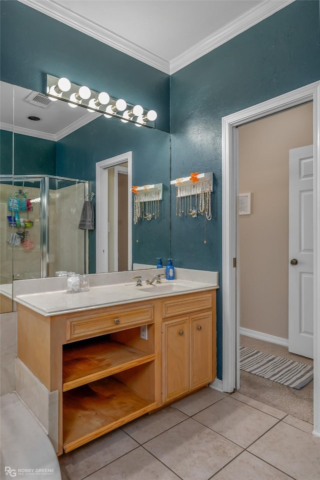 bathroom with tile patterned floors, a shower with door, ornamental molding, and vanity