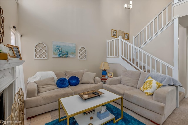 living room featuring a towering ceiling and a notable chandelier