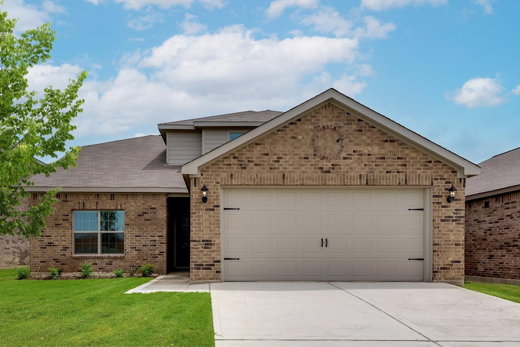 view of front of home with a garage and a front yard