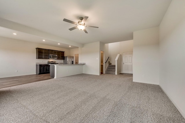 unfurnished living room with carpet floors and ceiling fan