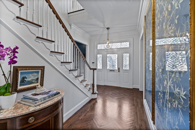 entryway featuring crown molding, plenty of natural light, and dark parquet flooring