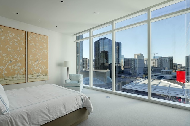 carpeted bedroom featuring a wall of windows