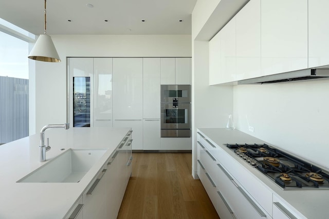 kitchen with appliances with stainless steel finishes, white cabinets, and sink