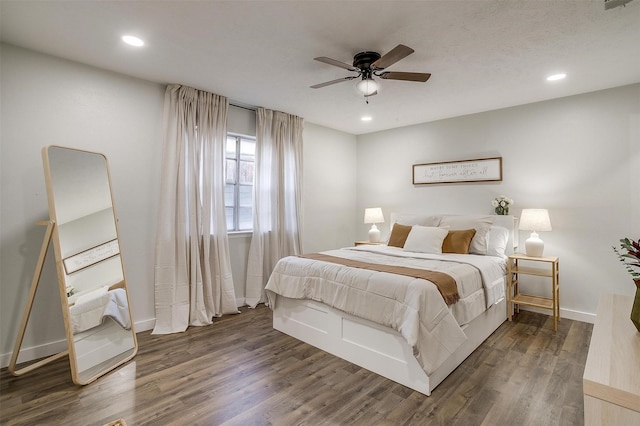 bedroom featuring ceiling fan and dark hardwood / wood-style floors