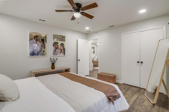 bedroom featuring ceiling fan, a closet, and hardwood / wood-style flooring