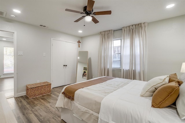 bedroom featuring ceiling fan, hardwood / wood-style flooring, and a closet