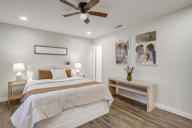 bedroom with ceiling fan and dark hardwood / wood-style flooring