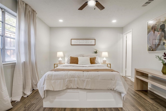 bedroom with ceiling fan and dark hardwood / wood-style floors