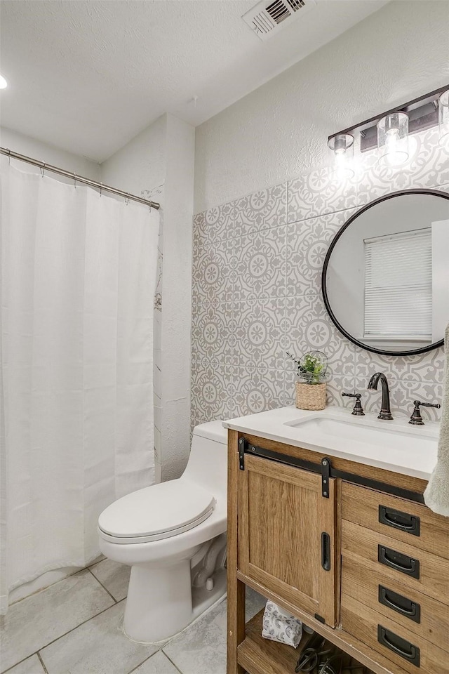 bathroom featuring toilet, vanity, and tile patterned floors