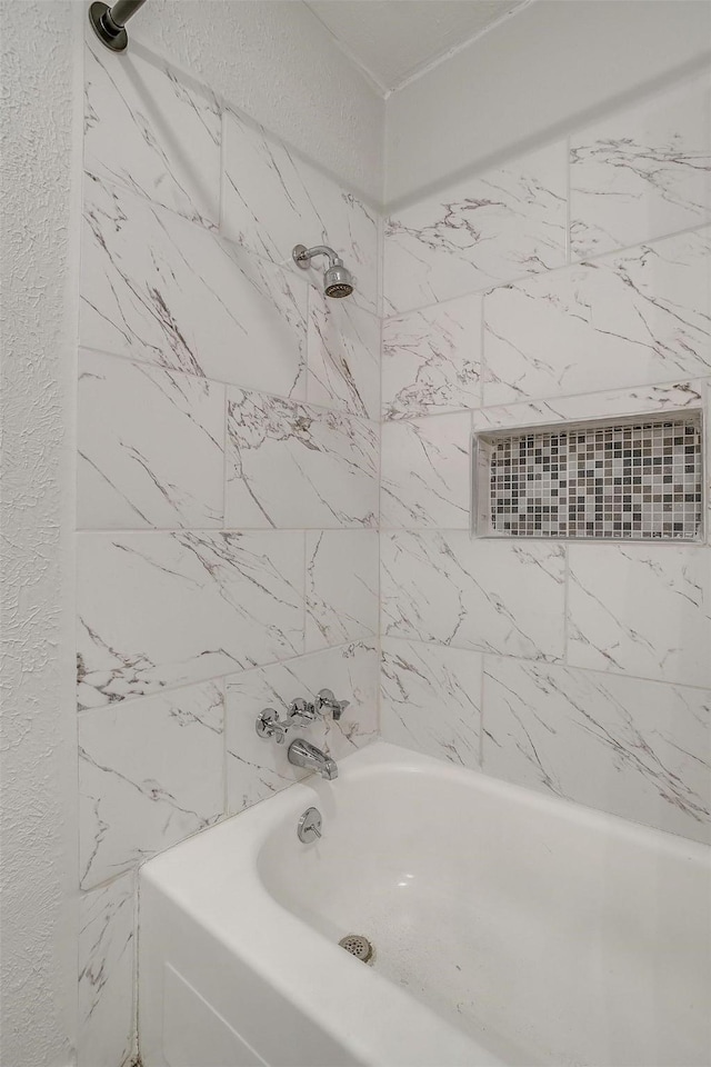 bathroom with tiled shower / bath combo