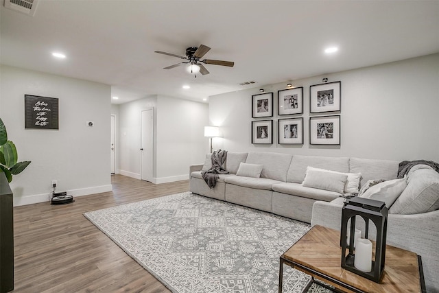 living room with ceiling fan and hardwood / wood-style floors