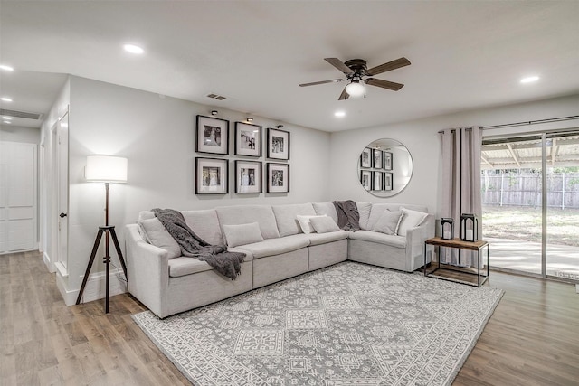 living room featuring ceiling fan and hardwood / wood-style floors